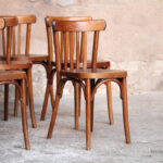 Lot de 8 chaises bistrot baumann en bois, dossier barreaux